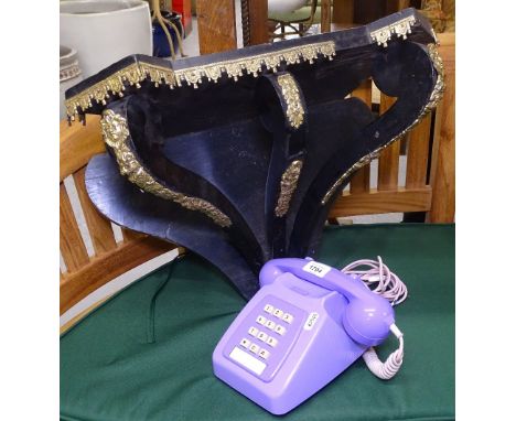 A Victorian ebonised clock bracket with ormolu mounts, and a Vintage mauve telephone (2) 