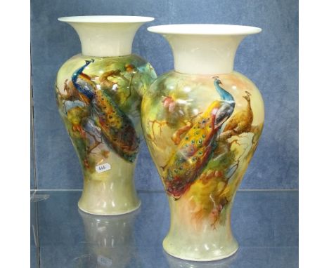 A pair of Royal Worcester porcelain vases, with painted designs of peacocks in branches, height 31cm 