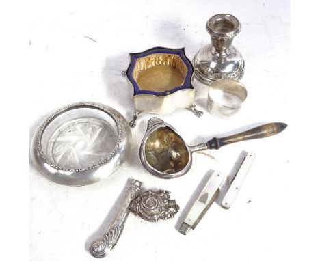 A small silver candlestick, silver-mounted ashtray, silver napkin ring, trinket box, a side-pouring spoon etc 