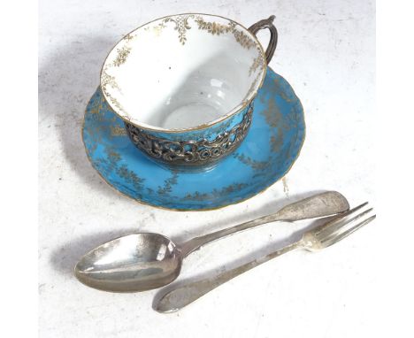 An Edwardian Staffordshire coffee cup and saucer, in  a stylised scrolled and pierced silver stand, hallmarks for London 1906