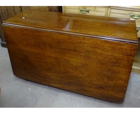 A George III mahogany drop leaf dining table, with reeded edge raised on ring turned legs, W114cm 