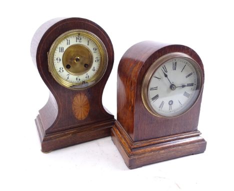 An Edwardian oak and satinwood inlaid bell-shaped mantel clock, and an oak-cased 30-hour dome-top mantel clock, largest case 