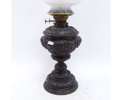 A cast-iron Duplex oil lamp, with mottled frilled glass shade and chimney, overall height 60cm 