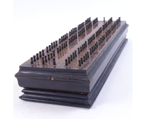 An Antique ebonised flame mahogany Cribbage board, length 28cm 
