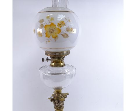 A 19th century brass Corinthian column oil lamp, milk glass floral shade with clear font and chimney, overall height 85cm 