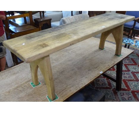A weathered oak bench on raised stile supports, L152cm 
