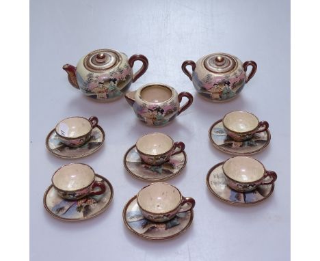 A Satsuma doll's tea service, with painted designs including teapot, height 5.5cm 