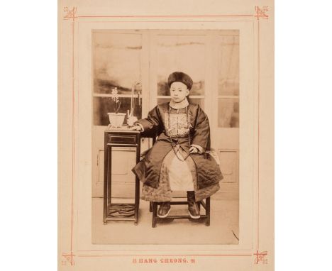 * China. Portrait of a young boy in traditional dress, by Hang Cheong, c. 1890s, albumen print, full length and seated indoor