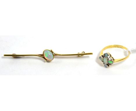 An early twentieth century 18 carat gold opal cluster ring, finger size O1/2, 2.4g and an opal brooch, stamped '15CT', 3.5g (