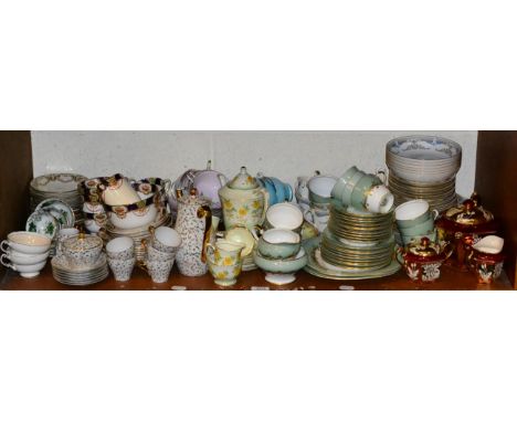 A shelf of decorative tea and dinner wares including Aynsley 