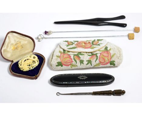 A beaded evening bag; glove stretchers; a glasses case; button hook; late Victorian carved brooch; and two silver Art Nouveau