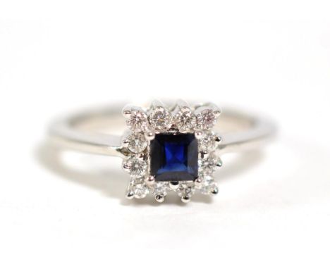 A sapphire and diamond cluster ring, total estimated diamond weight 0.15 carat approximately, finger size L, 4.3g