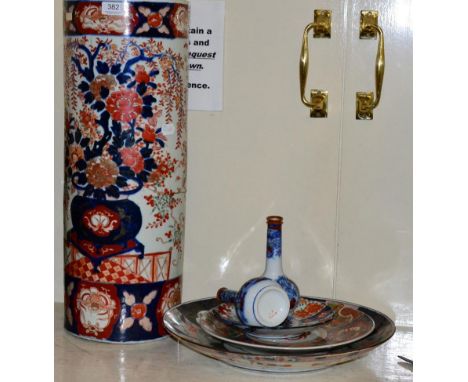 A 19th century Japanese Imari stick stand (a.f.); a pair of Japanese bottle vases; two chargers and a dish 