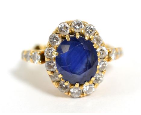 A sapphire and diamond cluster ring, total estimated diamond weight 0.95 carat approximately, finger size J  Soldered resizin