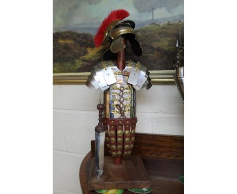 Detailed model of a Roman Centurion with Gladius on stand. 54cm.  A Greek soldier with shield and sword on wooden stand.60cm 