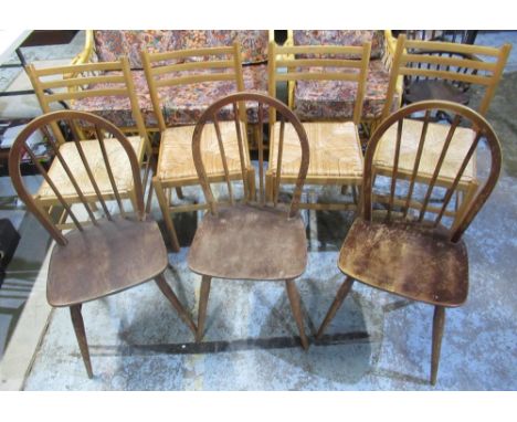 Set of four beech ladder back dining chairs with rush seats and a set of three vintage dark Ercol dining chairs, with blue sq