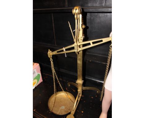 A SET OF BRASS SCALES by W & T Avery & Co. on  a tripod base 69cm high