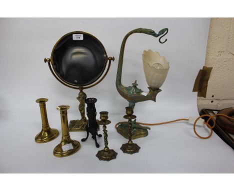AN EARLY 20TH CENTURY BRASS SHAVING MIRROR, two pairs of brass candlesticks, a brass lamp and a bronzed candlestick