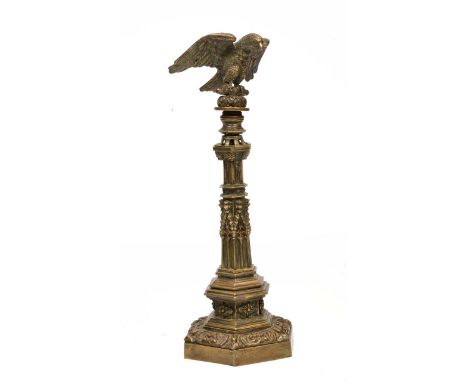 A BRASS ORNAMENT in the form of a bugle perched on top of a Gothic column, all on hexagonal stepped base, 44cm tall overall 