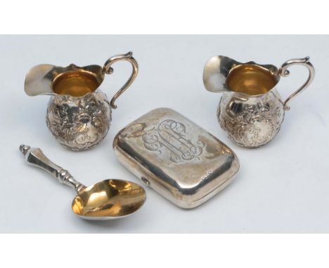 AN ANTIQUE RUSSIAN SILVER SOAP BOX, 7.2cm wide together with two small silver cream jugs and a Russian silver caddy spoon (4)