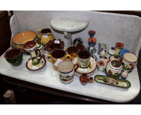 A COLLECTION OF DEVONSHIRE POTTERY TO INCLUDE a long park candlestick, a pair of blue and white glazed candlesticks and furth