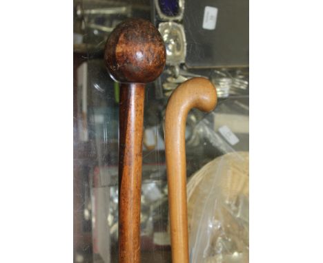 A HARDWOOD TURNED KNOB KERRY together with a further walking stick 