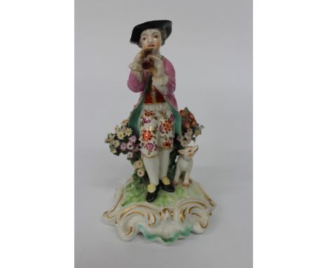 AN ANTIQUE SOFT PASTE PORCELAIN, POSSIBLY DERBY, FIGURE OF A GENTLEMAN PLAYING A PIPE with his dog in attendance, 17.5cm high