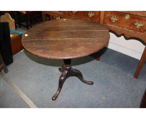 A GEORGE III OAK CIRCULAR TILT TOP TRIPOD TABLE 78cm wide 