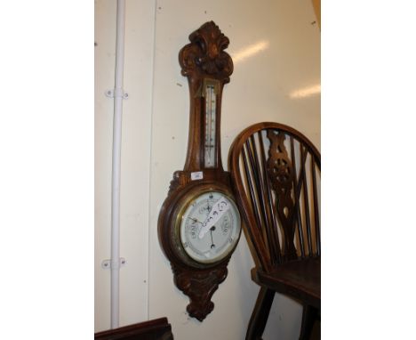 AN EARLY 20TH CENTURY CARVED OAK WHEEL BAROMETER 90cm in height together with a George III mahogany wheel barometer with silv