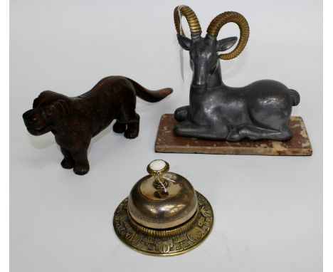 A BRASS DESK BELL together with a cast metal nutcracker in the form of a dog, a sculpture of a curly horned ram seated on  a 
