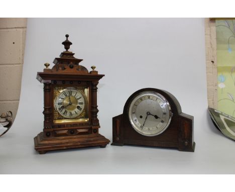 A VICTORIAN WALNUT MANTLE CLOCK with a carved pagoda top and brass dial with black Roman numerals standing on a rectangular s
