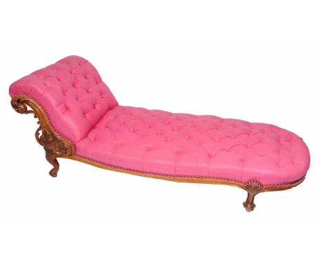 A WALNUT FRAMED PINK BUTTON UPHOLSTERED CHAISE LONGUE with carved scroll supports to one end and all on cabriole legs 182cm l