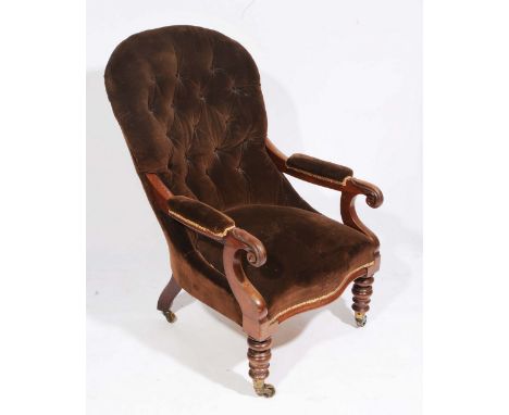 AN EARLY VICTORIAN MAHOGANY FRAMED BUTTON BACKED DRAYLON UPHOLSTERED ARMCHAIR with turned front legs, terminating in brass ca