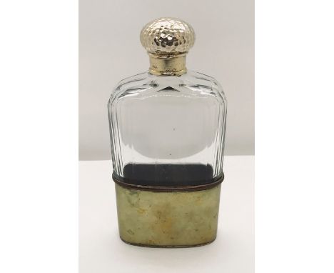 A cut glass flask with hallmarked silver gilt top