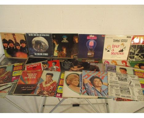 A collection of 12" vinyl records from 1960's artists, including The Beatles, The Rolling Stones, Roy Orbison, Cliff Richard,