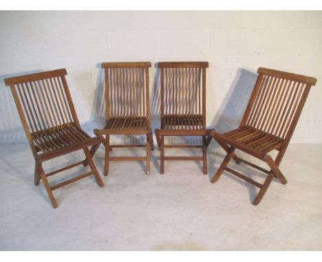 A set of four wooden folding garden chairs