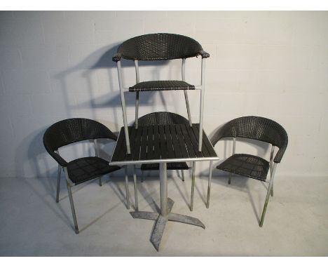 A set of four rattan effect garden chairs and matching tip up table 