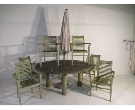 A large round garden table - Diameter 180cm - with six chairs (two A/F) and parasol in base 