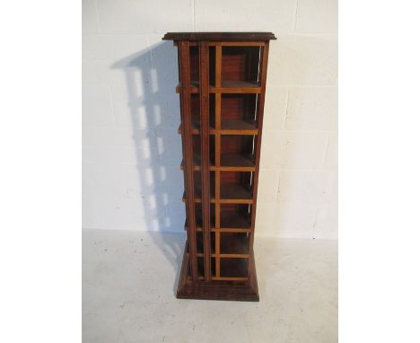 A teak revolving CD stand, height 117cm