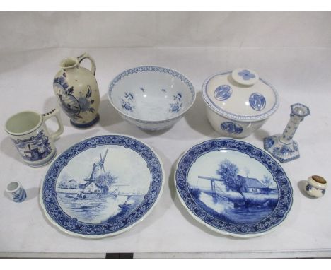 A collection of Dutch Delft blue and white china including a bowl, candlestick, jug, plates etc
