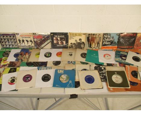 A collection of 7" vinyl singles including The Beatles (21 in total), The Rolling Stones (16), Guns N'Roses, ZZ Top, U2, Kiss