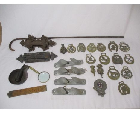 A collection of various items including a Royal Automobile Club Associate badge stamped F33686, horse brasses, ornate cast ir