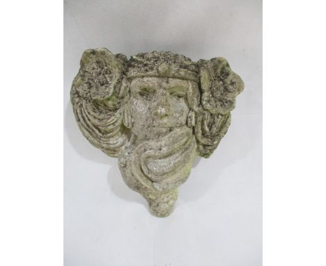 A concrete garden wall pocket in the form of an art nouveau lady