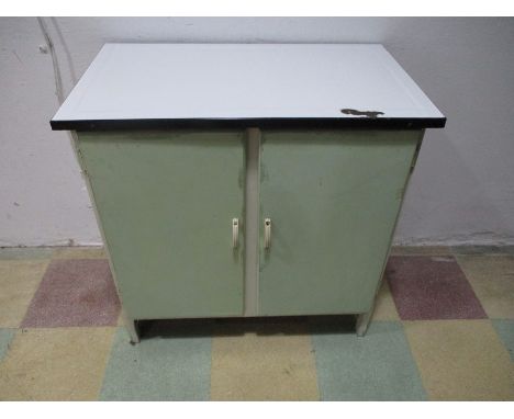 A mid century kitchen unit with enamel top