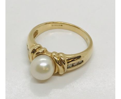 A 9ct gold dress ring set with a single pearl and diamonds to shoulder