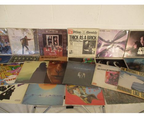 A collection of twenty five 12" vinyl records including Neil Young, Jethro Tull, Black Sabbath, The Rolling Stones, The Doors