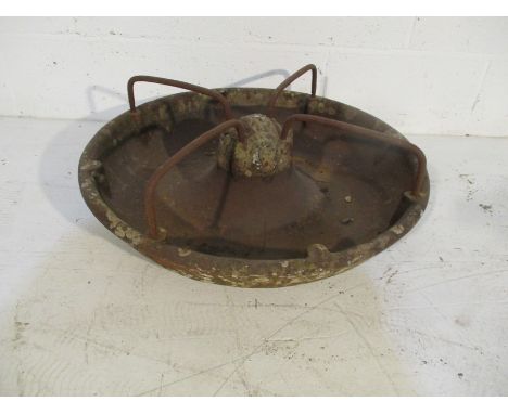A cast iron animal feeding trough