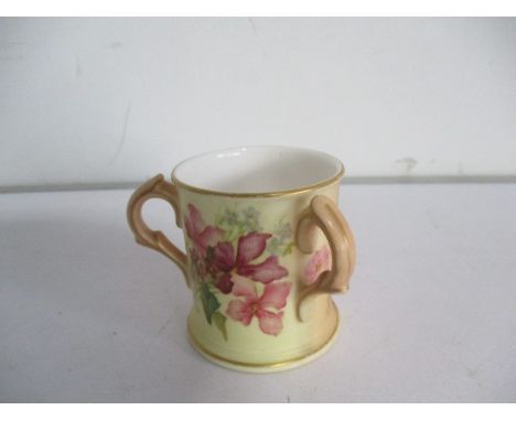 A Royal Worcester blush ivory three handled cup