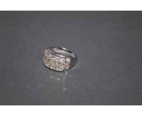 An 18ct white gold and diamond ring, the face pave set with 16 old cushion cut diamonds arranged in three lines, approx 3 car