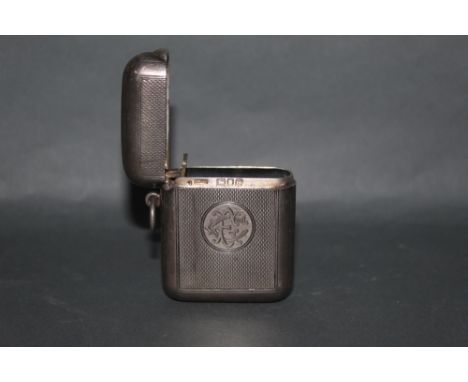 A late Victorian silver rectangular vesta case with engine turned body and engraved circular cartouche, 5.5 cm x 4 cm, hallma